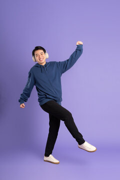 portrait of asian man posing on purple background