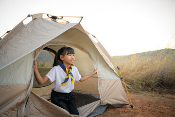 Asian girl scout schoolgirl sleeping in scout tent In a student camp on a hill in the woods