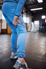 Leg pain, injury and accident at a gym after exercise, training or sport workout with bruise. Fitness, sports and woman athlete limping from a swollen, inflammation or sprain muscle at a studio. - obrazy, fototapety, plakaty