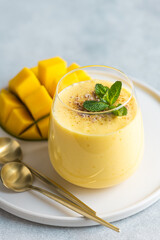 Lassi, indian traditiona refreshing drink with mango, selective focus