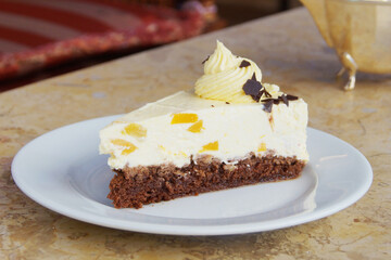Cheesecake with a chocolate sponge base and some candied fruit.               