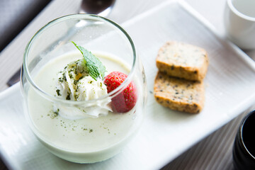Matcha tea Japanese cheesecake with wiped cream and strawberry.