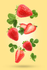 Delicious sweet strawberries and green leaves falling on pale yellow background