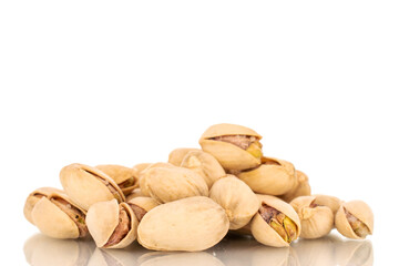 Several unpeeled pistachios, close-up, isolated on white.