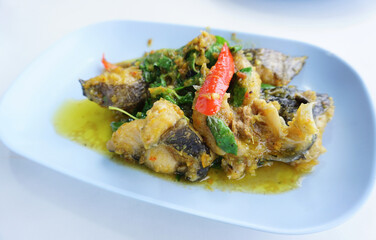 Spicy stir fried catfish with green curry and herbal