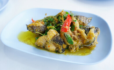 Spicy stir fried catfish with green curry and herbal