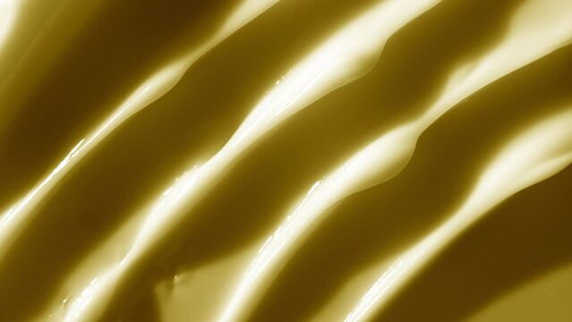 Night cream background for its advertising | Top view macro shot of yellow night cream with moving light source