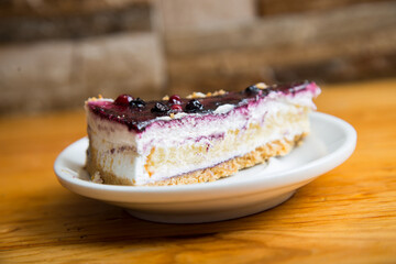Cheesecake with red fruit sauce and fresh fruit such as raspberries, blueberries or strawberries.