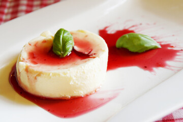 Cheesecake with red fruit sauce and fresh fruit such as raspberries, blueberries or strawberries.