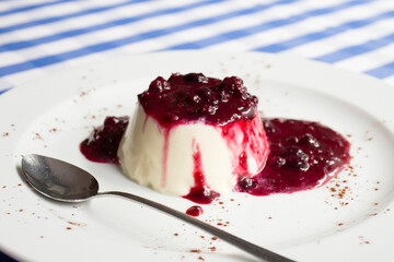 Cheesecake with red fruit sauce and fresh fruit such as raspberries, blueberries or strawberries.