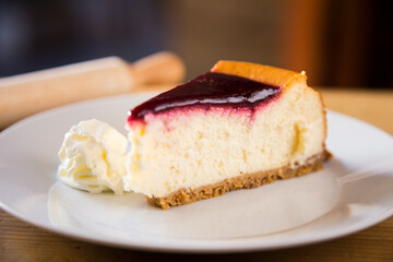Cheesecake with red fruit sauce and fresh fruit such as raspberries, blueberries or strawberries.