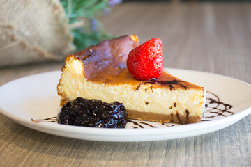 Cheesecake with red fruit sauce and fresh fruit such as raspberries, blueberries or strawberries.