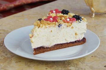 Cheesecake with red fruit sauce and fresh fruit such as raspberries, blueberries or strawberries.