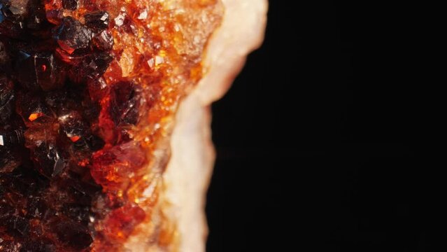 Radiant macro shot of a citrine golden quartz crystal sparkling against a dark background, captured through smooth panning and macro lens for intricate surface details.