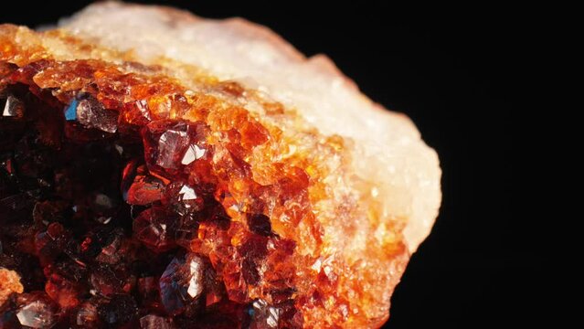 Luminous detailed shot of golden citrine quartz crystal aglow against dark background. Smooth pan and macro lens for intricate surface details.