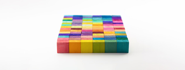 A slab of colors.  On neutral white background. Spectrum of colorful wood blocks.  Background or cover for something creative or diverse..Shallow depth of field. Focus on front edge.
