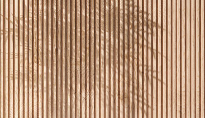 Soft and beautiful foliage dappled sunlight of tropical bamboo tree leaf shadow on brown wooden panel wall with wood grain for luxury product display, interior design decoration background 3D - obrazy, fototapety, plakaty