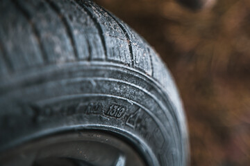 Close-up of car wheels rubber tires in winter snow. Concept of transportation and safety during the...
