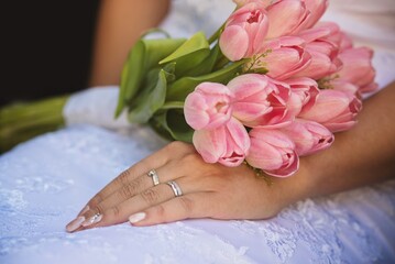 a bride with a wedding bouquet of pink tulips