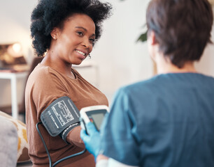 Black woman, healthcare and blood pressure checkup with caregiver monitoring or checking pulse at home. Happy African American female patient or visit from medical nurse for health and wellness - obrazy, fototapety, plakaty