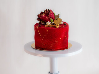 red romantic valentine frosted cake with rose , golden heart and key toppers over white background