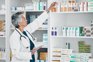 Pharmacy, tablet and medicine with senior woman in store for healthcare, wellness or retail. Product, technology and stock with pharmacist checking drugs outlet for shopping, medical or inventory
