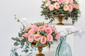 two pink roses bouquets on a stand