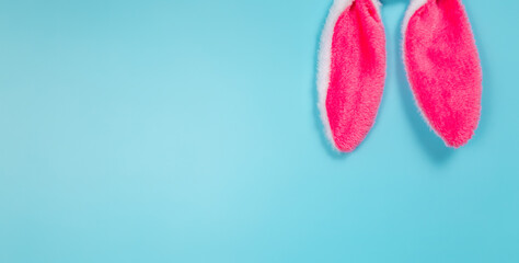 easter holiday background with bunny ears on blue background. copy space