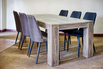 wooden table and chairs presented in a small and simple flat