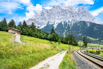 Fototapeta na wymiar Railway with Mountain Zugspitze in the background, Ehrwald, Germany