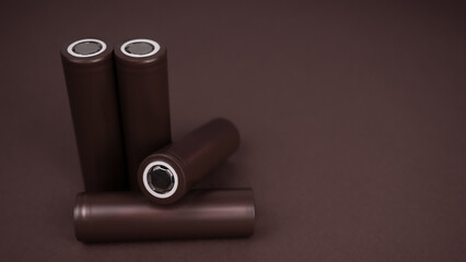 Battery. Cylindrical battery, type 18650 on a brown background. Rechargeable lithium-ion batteries...
