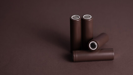 Battery. Cylindrical battery, type 18650 on a brown background. Rechargeable lithium-ion batteries...
