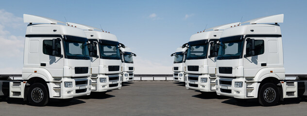 Fleet of white semi trucks in a rows	
