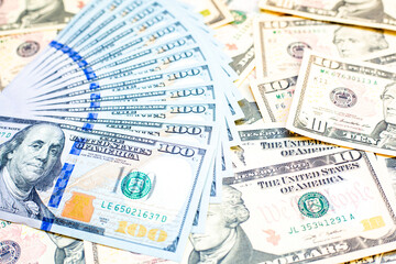 Fototapeta premium Group of money dollar banknotes arranged on dollar banknotes chaotic manner. Dollar banknotes isolated in a chaotic manner. Exchange money, Money, Cash and finances concept. Travel concept..