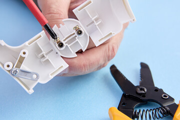 Collapsible electric plug of European standard type f, electrician mounts connector of electric cord.