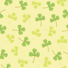 Clover leaves seamless pattern in yellow and green colors. Decorative background for wrapping paper, wallpaper, textile, greeting cards and invitations.