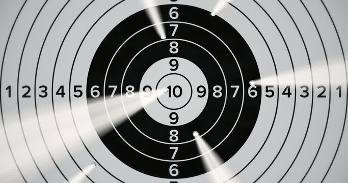 Shooting range target hitting with light and gunpowder smoke coming out of holes