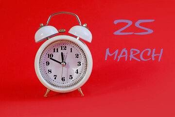  Calendar for March 25: a white alarm clock on a crimson background close-up, the numbers 25, the...