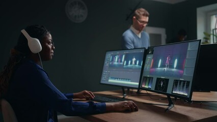 female video and sound editor working in studio, making final cut of musical clip, use two display