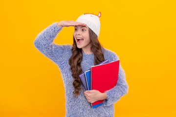 back to school. teen girl in knitwear on yellow background.