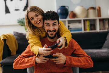 Caucasian couple enjoys playing games © cherryandbees