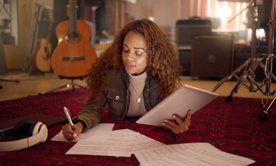 Musician, studio and woman writing lyrics for a song with paper and a digital tablet for...