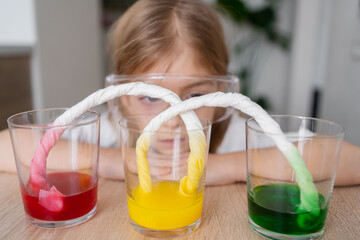 kid doing an experiment with coloured water. concept of learn from home, child STEM education and science for kid. - obrazy, fototapety, plakaty