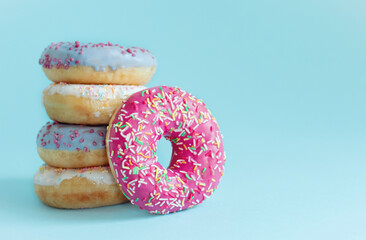 Morning breakfast with donuts on blue background. Tasty donuts closeup. Doughnut. Copy space.
