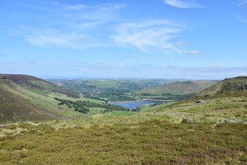 Fototapeta premium Countryside view with green hills and mountains with a lake in distance. Taken in Oldham England. 
