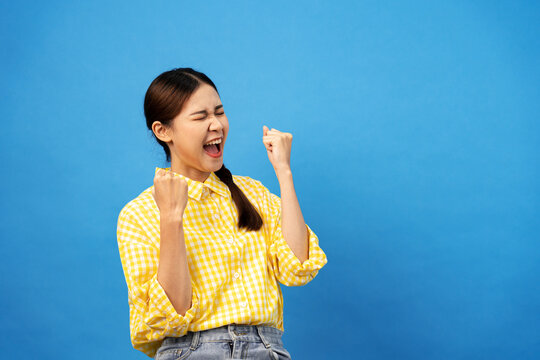 Young Asian Woman Wearing Gingham Yellow Shirt With Braid Hairst