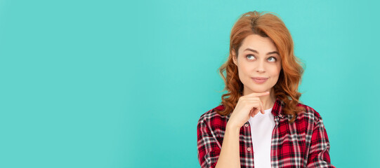 thinking redhead woman with curly hair in checkered casual shirt, thoughtful. Woman isolated face portrait, banner with mock up copyspace.