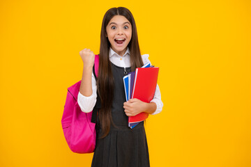 Amazed teen girl. Back to school. School girl student with school bag backpack hold book on...