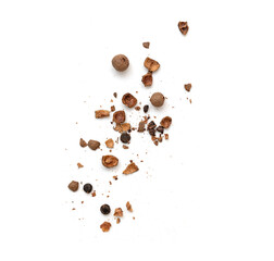 Whole and broken allspice pieces falling and isolated on white, top view