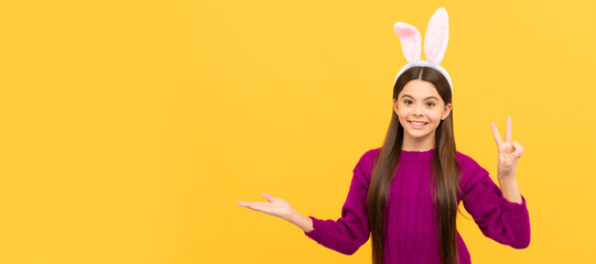 adorable kid wearing funny hare ears. easter spring holiday. copy space. happy teen girl. Easter child horizontal poster. Web banner header of bunny kid, copy space.
